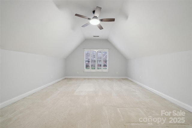 bonus room with light carpet, baseboards, and vaulted ceiling