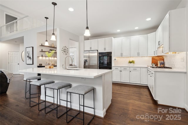 kitchen featuring light countertops, a sink, white cabinetry, and stainless steel fridge with ice dispenser