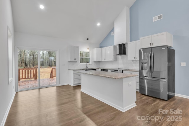 kitchen featuring white cabinets, appliances with stainless steel finishes, visible vents, and pendant lighting