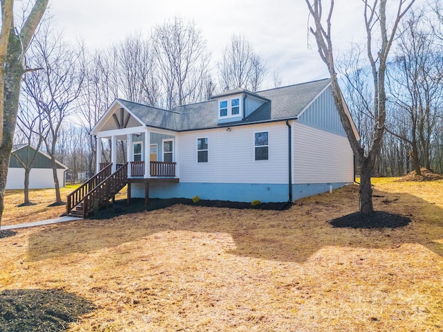 exterior space with stairs, a shingled roof, and crawl space