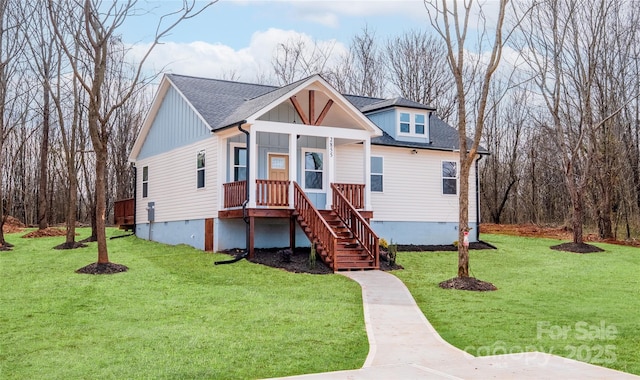 view of front of property featuring a front lawn, stairway, a porch, and a shingled roof