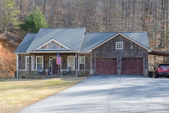 craftsman house featuring a garage, a front yard, a carport, and covered porch