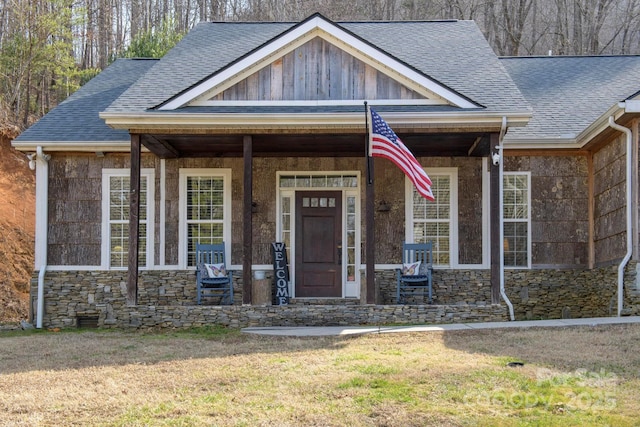 craftsman inspired home featuring a porch and a front yard