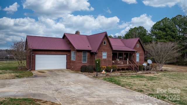 view of front of home featuring a porch, concrete driveway, an attached garage, metal roof, and a front lawn