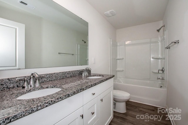 full bath with visible vents, a sink, toilet, and wood finished floors