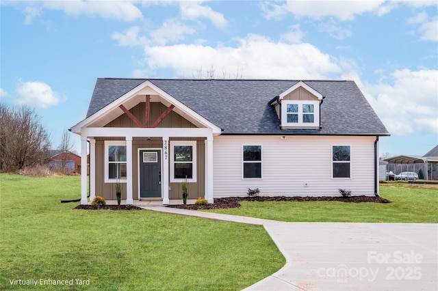 view of front of home featuring roof with shingles, a carport, board and batten siding, and a front yard