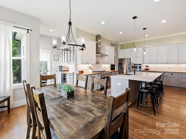 dining room featuring wine cooler and light hardwood / wood-style floors