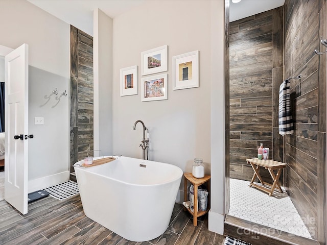 bathroom featuring shower with separate bathtub