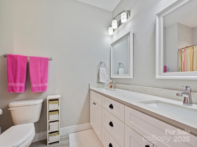 bathroom featuring vanity, hardwood / wood-style floors, and toilet