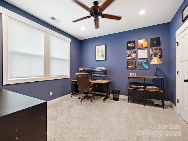 carpeted office space featuring ceiling fan