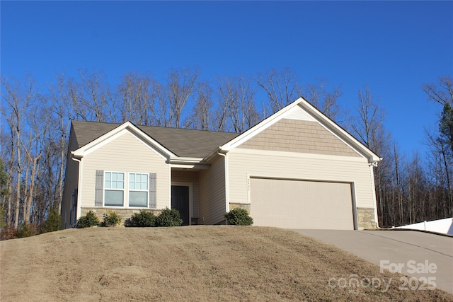 ranch-style home with a garage, stone siding, and concrete driveway