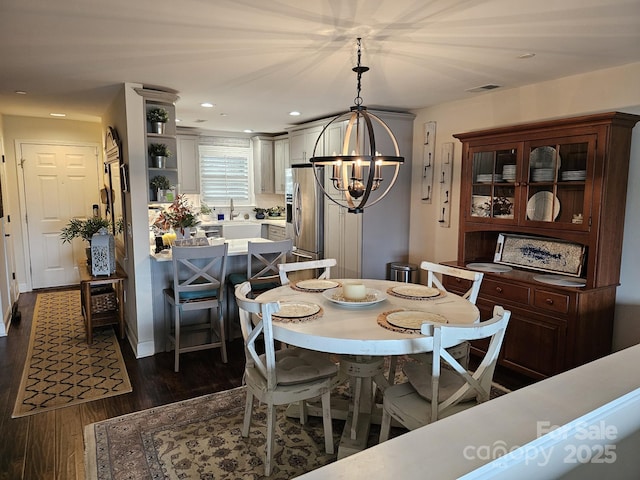 dining space featuring a notable chandelier and dark wood-type flooring