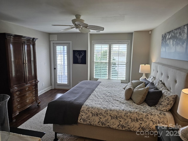 bedroom featuring dark wood-type flooring, ceiling fan, access to exterior, and multiple windows