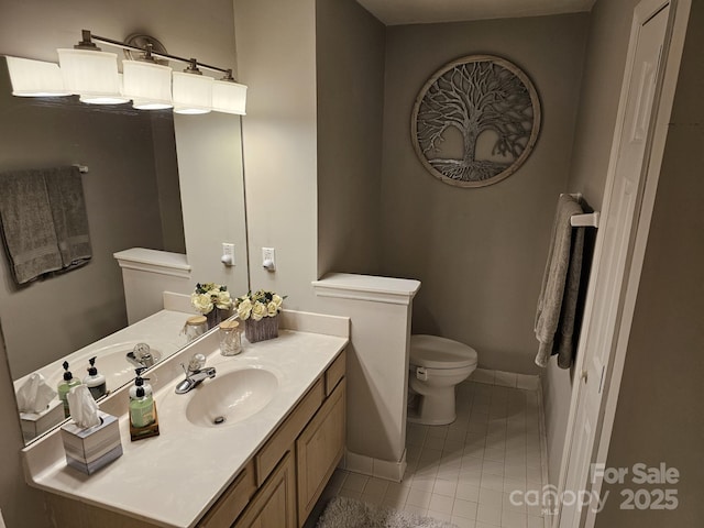 bathroom with vanity, toilet, and tile patterned flooring