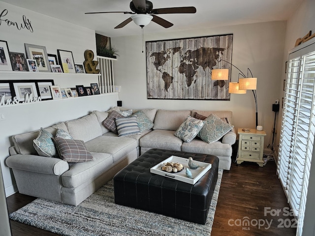 living room with dark wood-type flooring and ceiling fan