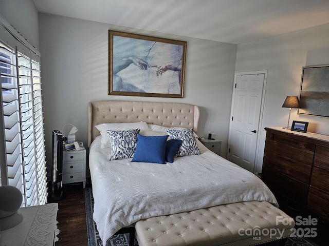 bedroom with dark hardwood / wood-style floors