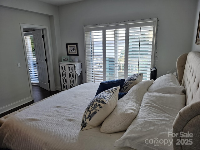 bedroom with dark hardwood / wood-style floors