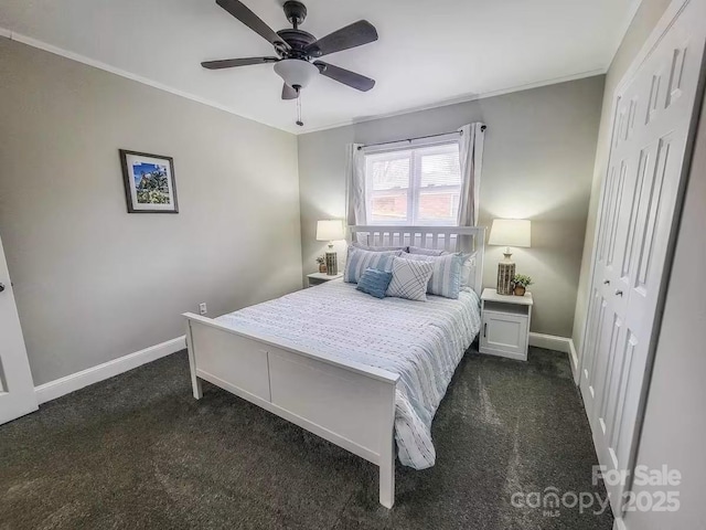 bedroom featuring a ceiling fan, baseboards, dark colored carpet, and crown molding