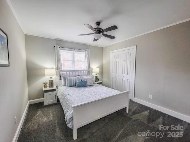 bedroom with crown molding, a closet, dark carpet, and baseboards