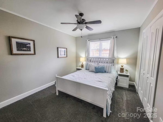 bedroom with ceiling fan, baseboards, dark colored carpet, and a closet