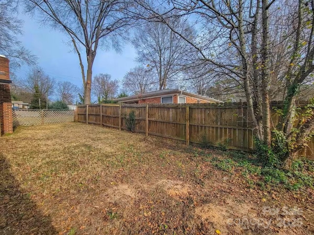 view of yard with a fenced backyard