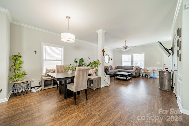 dining area with a ceiling fan, dark wood-style flooring, crown molding, and decorative columns