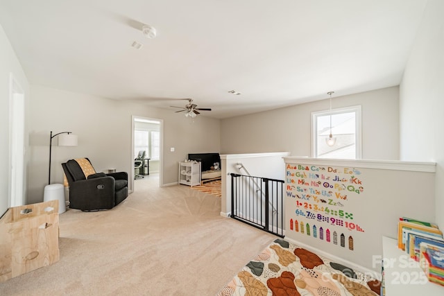 interior space with light carpet, a healthy amount of sunlight, and visible vents