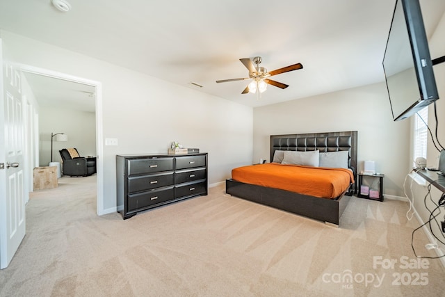 bedroom with light carpet, visible vents, baseboards, and a ceiling fan