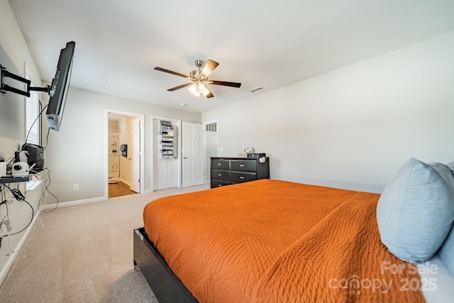 bedroom featuring ensuite bath, carpet, visible vents, and baseboards