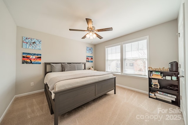 bedroom with a ceiling fan, light colored carpet, and baseboards