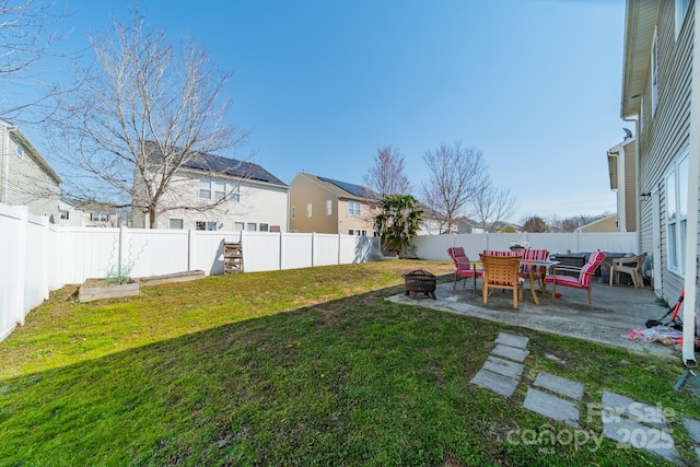 view of yard with a patio area, a fenced backyard, and a fire pit