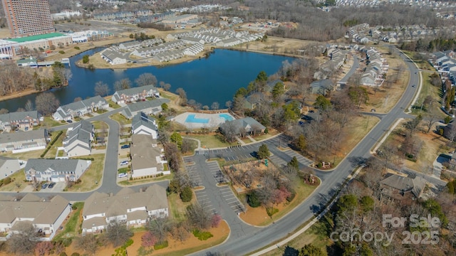 drone / aerial view featuring a residential view and a water view