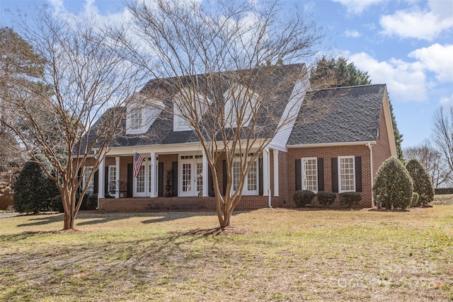 cape cod home with a front yard
