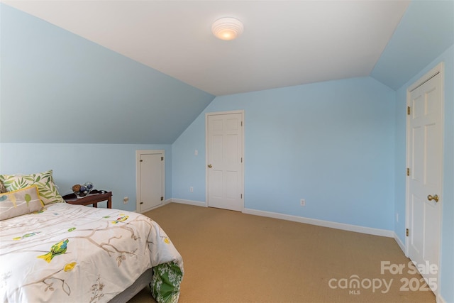 carpeted bedroom featuring vaulted ceiling