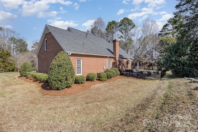 view of side of property featuring a yard