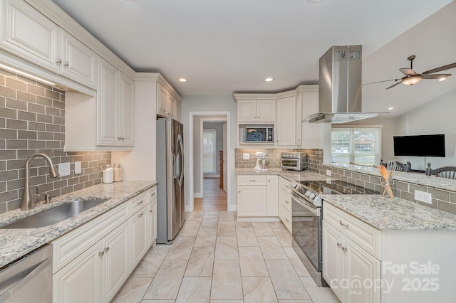 kitchen with a sink, light stone counters, exhaust hood, and appliances with stainless steel finishes