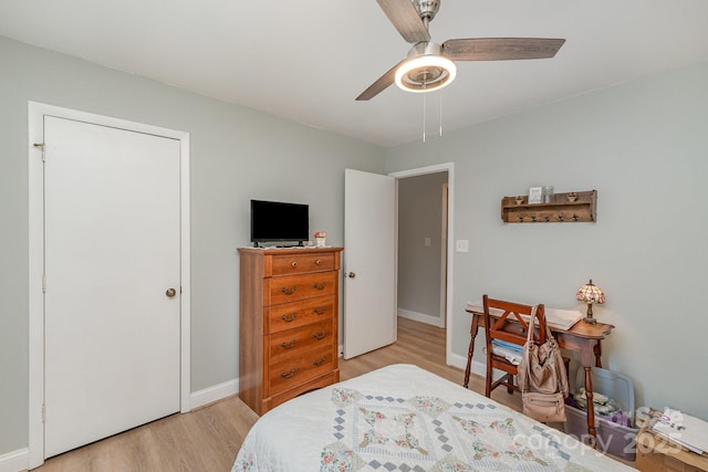 bedroom featuring ceiling fan, baseboards, and light wood-type flooring