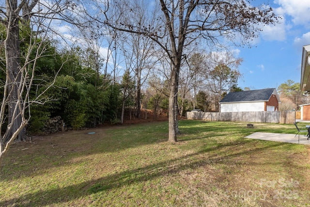 view of yard featuring fence and a patio area