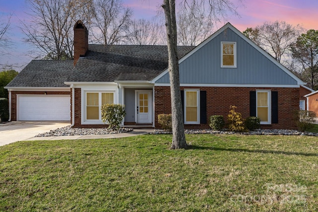 traditional home with a front lawn, brick siding, driveway, and a garage