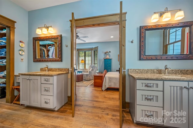 bathroom featuring hardwood / wood-style flooring, vanity, and ceiling fan