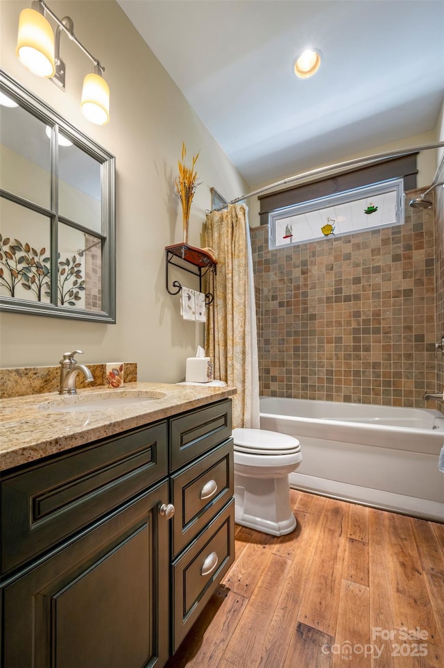 full bathroom with vanity, hardwood / wood-style floors, shower / bath combination with curtain, and toilet