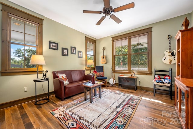 living room with wood-type flooring, a wealth of natural light, and ceiling fan