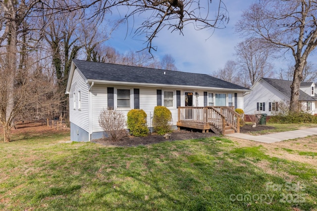 view of front of house with a front lawn and a shingled roof