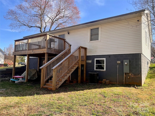 rear view of property with a deck, central AC, stairs, and a yard