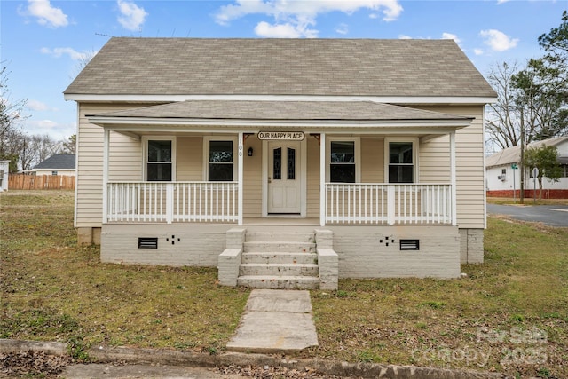 bungalow-style home featuring crawl space, covered porch, and a shingled roof