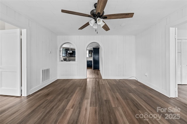 100 Lear St, Rockingham, NC 28379 - spare room with ceiling fan, arched walkways, and dark wood-style flooring