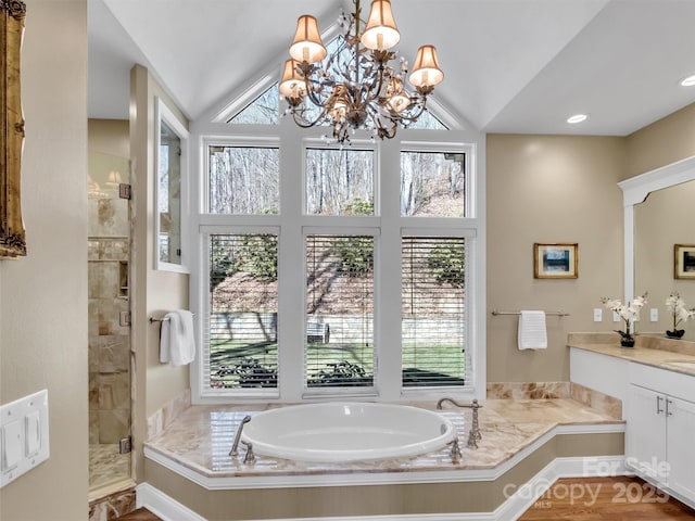 full bathroom with lofted ceiling, recessed lighting, an inviting chandelier, a stall shower, and vanity