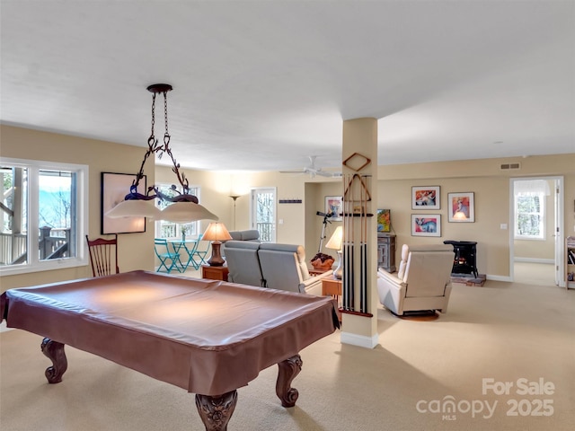 recreation room featuring plenty of natural light, visible vents, baseboards, and light colored carpet