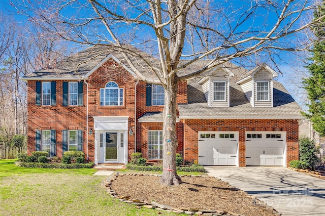 view of front of property with a front lawn and a garage