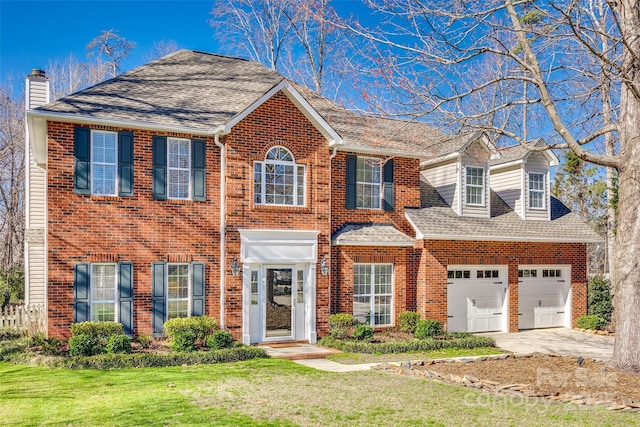 view of front of home featuring a front lawn and a garage